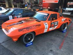 SHot of the 1965 Candy Tangerine Chevrolet Corvette owner/driver by Greg Thurmond in Optima Alley